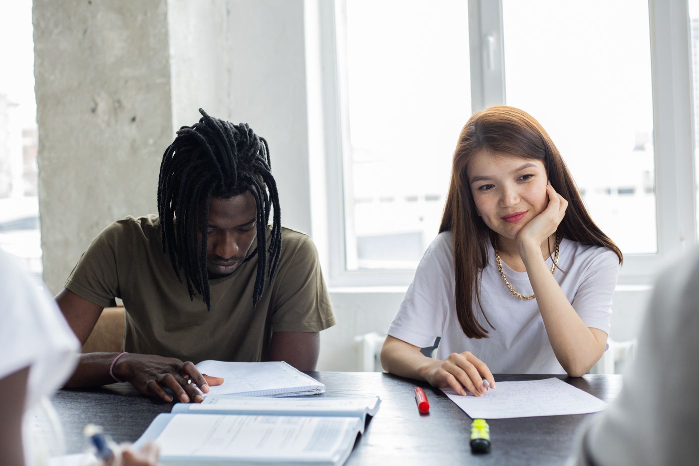 Students working together around a table in a bright classroom